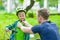 Father wears a protective helmet to his son