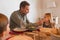 Father wiping daughters mouth with a napkin on dining table