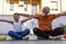 Father and young son are training with colored dumbbells on a terrace