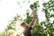 Fatherhood, parenthood, childhood, caring, summer and leisure concept - young dad with beard and long hair in black t