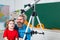 Fathers day. Happy Father and son. Pupil watching stars with a teacher. Astronomy telescope.