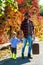 Fathers love for son. Retro style - Father with a suitcase and his son. Dad with young son in autumn park. Travels