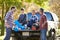 Fathers With Sons Unpacking Truck On Camping Holiday