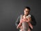 Fathre and his kid in baby carrier at the grey background wall, baby wearing concept