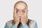 Fatigue, Crisis Concept - bald Man Peers Through His Fingers
