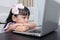 Fatigued Asian Chinese little girl looking at computer screen