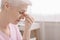 Fatigued senior woman massaging nose bridge, feeling eye strain