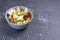 Fattoush vegetarian salad in a gray bowl against black background. Copy space.