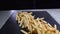 fatty and fried fries on a slate board. Close-up of junk food. Fast food. copy space.