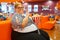 Fatty woman eating popcorn in the cinema hall