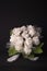 Faux bouquet of white roses on black background