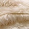 Faux fur with a long pile. Pastel cream artificial fabric, background. Fur for toys