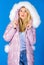 Faux fur is more than just trend. Down jacket with furry hood. Girl wear winter jacket. Winter season. Soft fur. For