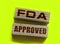 FDA approved words made with wooden blocks. Food and drugs association concept