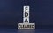 FDA, Food Drug Administration cleared symbol. Concept words `FDA cleared` on wooden cubes and block on a beautiful grey backgrou