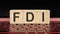 FDI a word on wooden cubes on the illuminated laptop keyboard