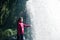 Feamale hiker, tourist, model out of focus touching water under