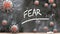 Fear and covid virus - pandemic turmoil and Fear pictured as corona viruses attacking a school blackboard with a written word Fear