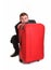 Fearful business man hide behind red luggage