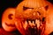 Fearful symbol of Halloween - Jack-o-lantern. Scary smiling head of pumpkin close-up. Glowing face, trick or treat.