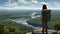 Fearless hiker admiring majestic mountain view with backpack, captivated by breathtaking valley