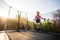 Fearless little kid jumping high on trampoline