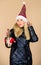 Feast of Christmas. woman down jacket hold champagne. girl santa claus hat. warm clothing. fun and gifts. happy new year