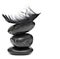Feather balancing on stack of black stones