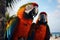 Feathered duo Two striking macaw parrots find a perch on the man\\\'s arm