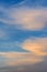 Feathery cirrus clouds at sunset on blue sky background