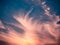 Feathery Clouds Illumintated by Setting Golden Sun against a brilliant blue sky