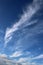 Feathery white clouds in clear blue sky