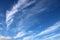 Feathery white clouds in clear blue sky