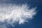 Feathery white wispy cloud in a blue sky