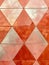 Featuring a soft, light red geometric tile background, this image embodies a sense of gentle warmth and harmony. Its