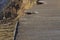 February 14 Storm Damage 2014, holes gauged out of tarmac asphalt seaside path, Milford on Sea