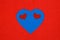 February 14. Valentine`s Day. Heart of blue on a red background. Smile