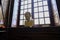 February 2021 Parma, Italy: Portrait sculpture standing in the window across the window in Biblioteca Palatina