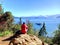 February 2022, Bariloche, Argentina: young mountaineer sitting on the top of Cerro observes Lake Bariloche and the Argentine Andes