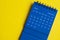 February 2023 blue desk calendar on yellow cover background. Calendar concept