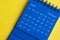 February 2023 blue desk calendar on yellow cover background. Calendar concept