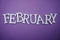 February alphabet letter with space copy on purple background