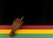 February Black History Month. Brown wooden hand on Paper geometric black, red, yellow, green background. Copy space
