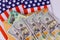 Federal monetary assistance stimulus U.S. economic tax return check USA dollar cash banknote on American flag Global pandemic