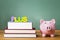 Federal PLUS Loan theme with textbooks and piggy bank