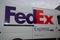 Fedex express logo brand and text sign delivery panel van truck in city street store