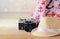 Fedora hat, old vintage camera and scarf over wooden table and sea landscape background. relaxation or vacation concept