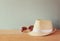 Fedora hat and sunglasses over wooden table. relaxation or vacation concept