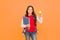 Feed your brain with knowledge. Happy kid hold apple and books orange background. Symbol of knowledge. Back to school