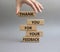 Feedback symbol. Wooden blocks with words Thank you for your Feedback. Beautiful grey background. Businessman hand. Business and